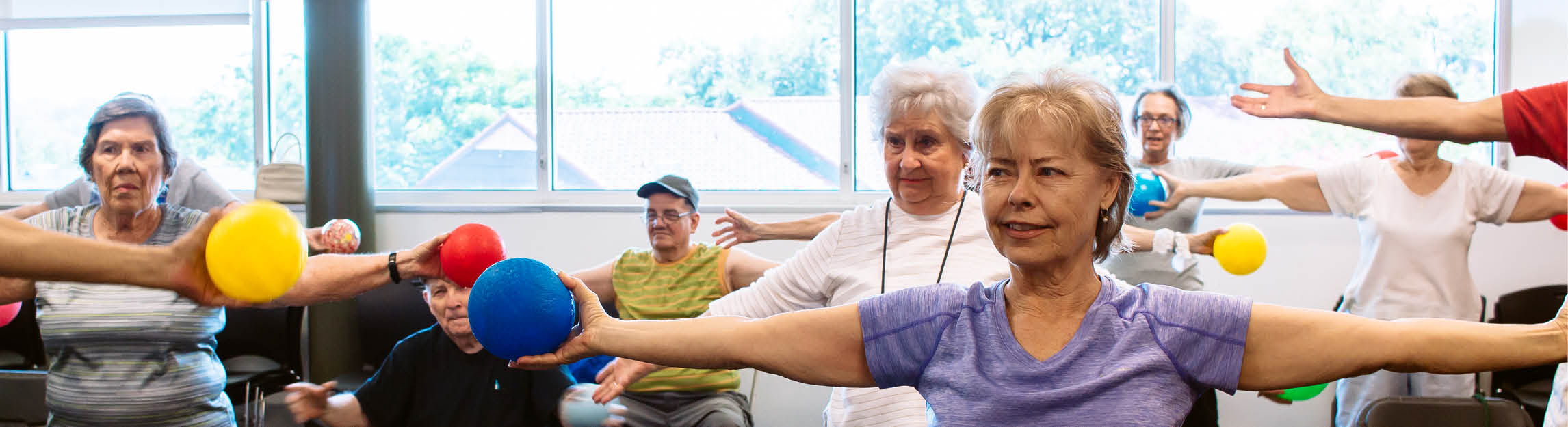 Active Older Adults working out in a group exercise class