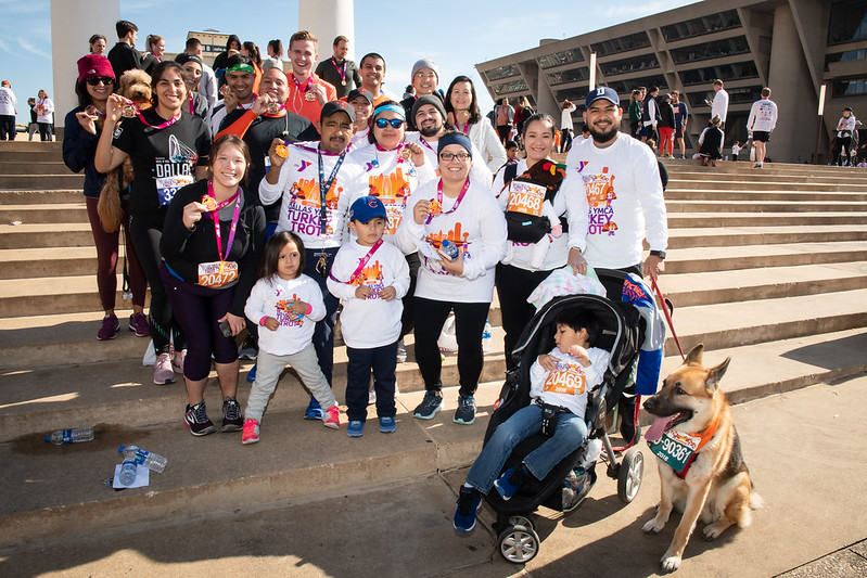 A large family standing on steps wearing turkey trot shirts