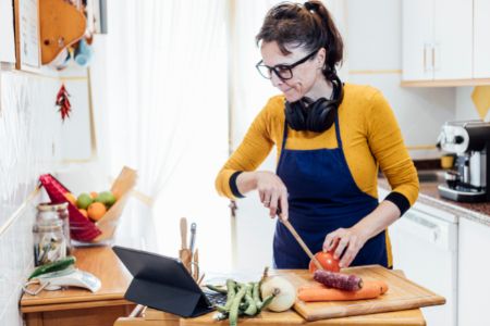 woman headphones ipad cooking