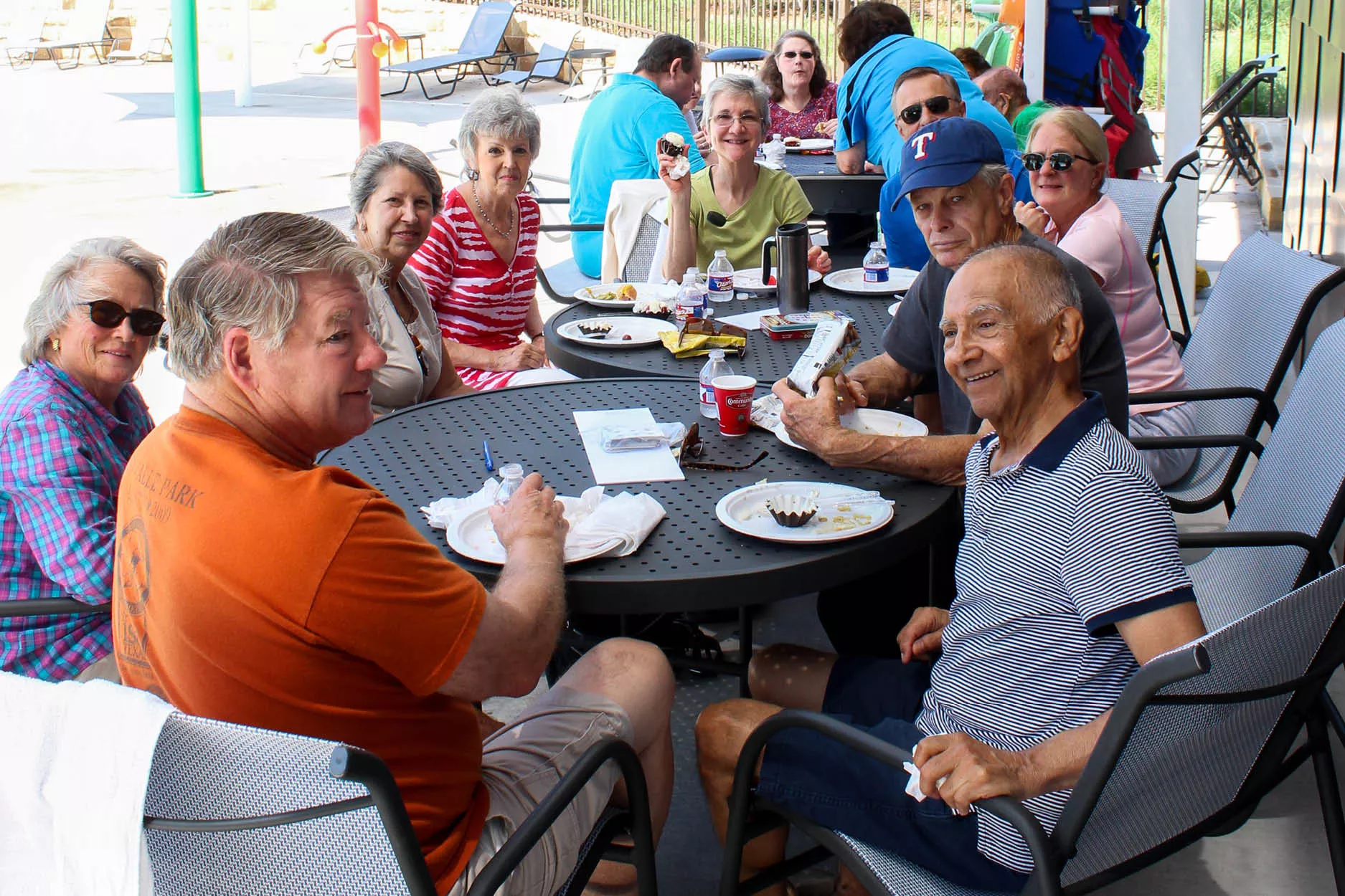 Active Older Adults smiling at a luncheon by the pool