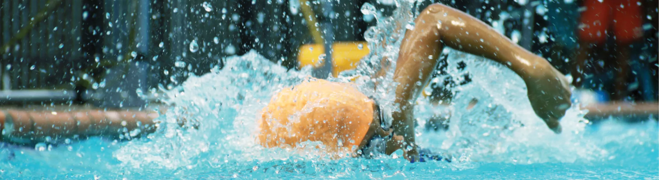 Person in a pool competitively swimming