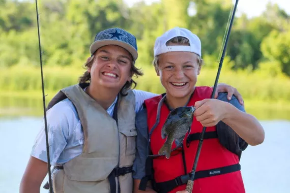 two boys with fish and rods