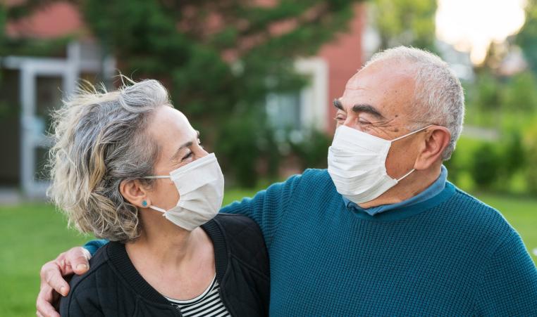 Older Senior Couple wear surgical masks