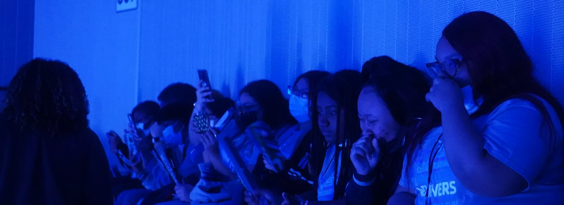 students laughing with blue light