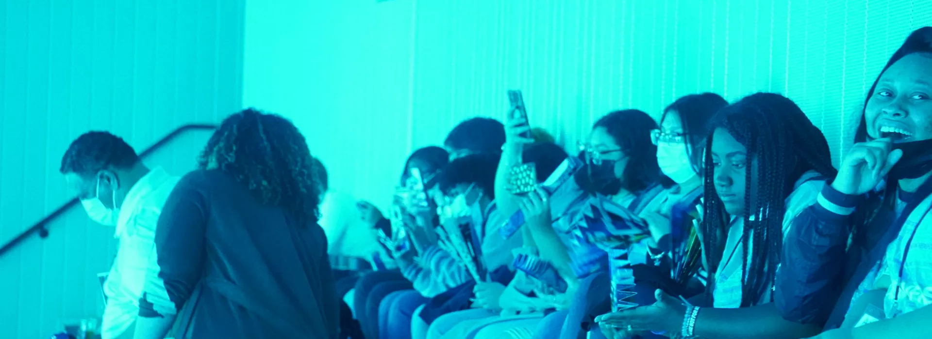 students laughing with aquamarine light
